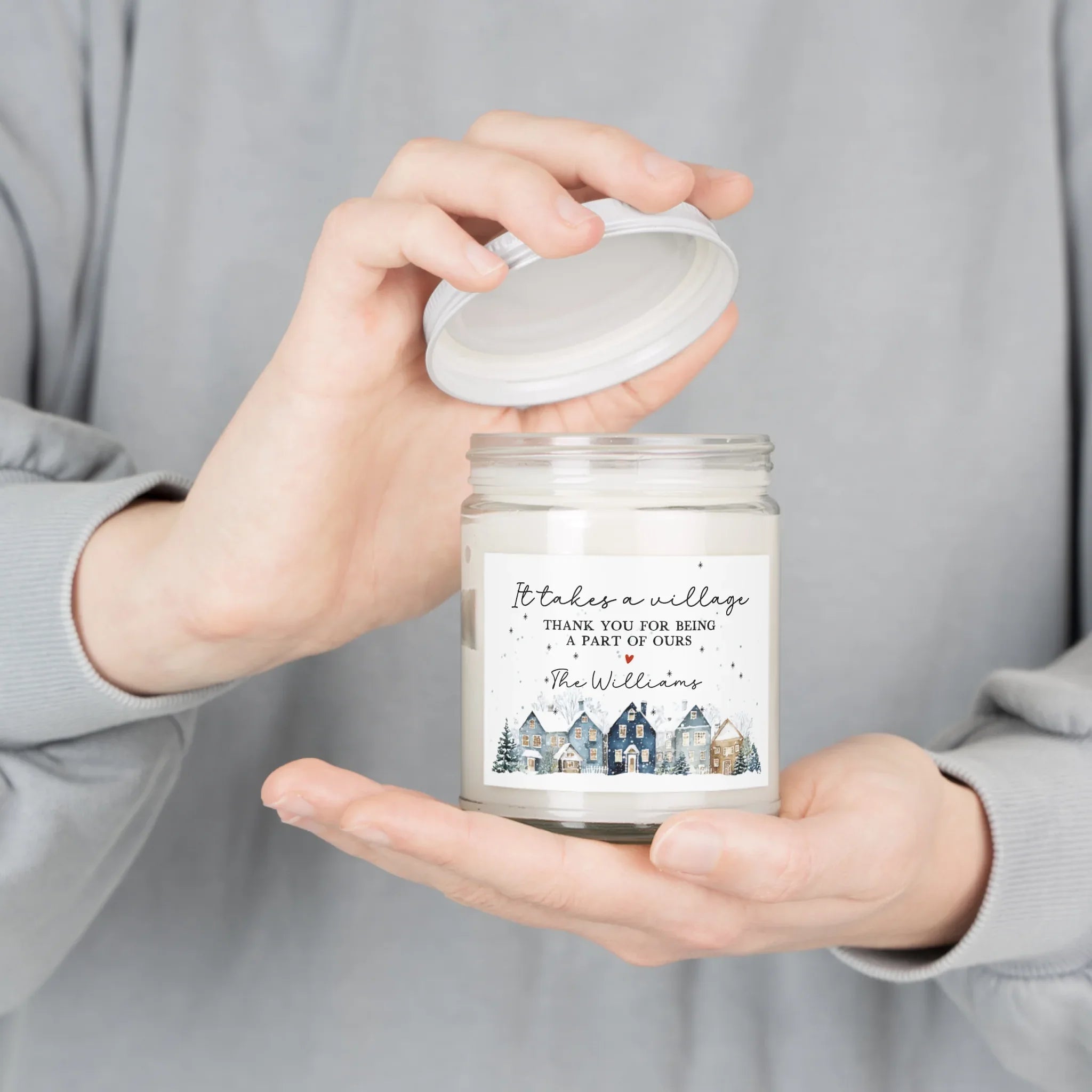 Thank You gift - Personalized Holiday Village Soy Candle held in hands with a serene village-themed label.