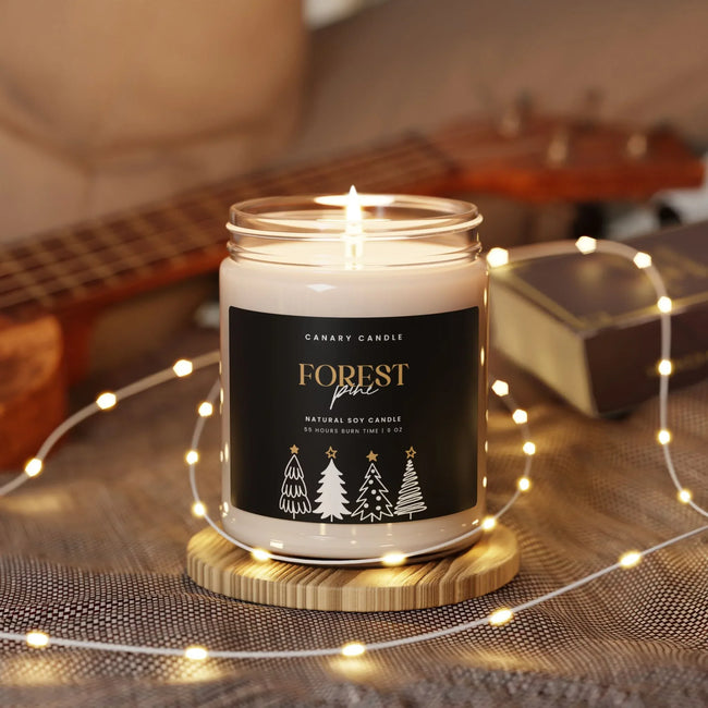 Holiday candle - Forest Pine Scented Soy 9oz Jar with a warm glow and elegant design in a cozy setting.