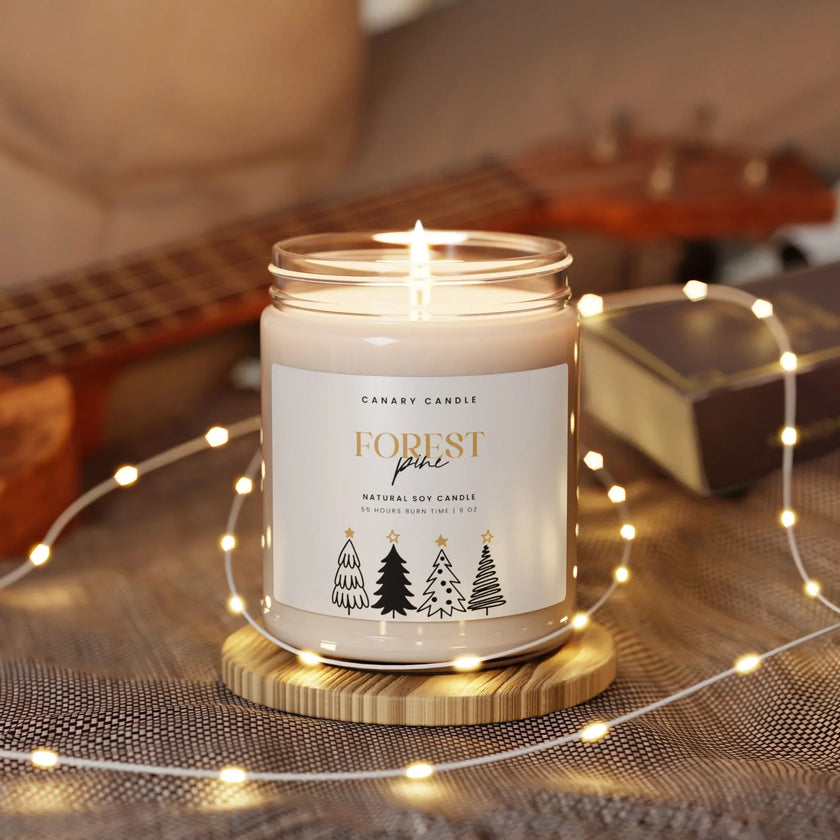 Forest Pine Soy Candle in a glass jar with warm light and holiday decor.