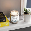 Thank You gift - Personalized Holiday Village Soy Candle on a windowsill with books and a small plant.