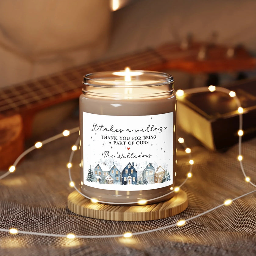 Thank You gift - Personalized Holiday Village Soy Candle on a wooden stand with warm lights in a cozy setting.