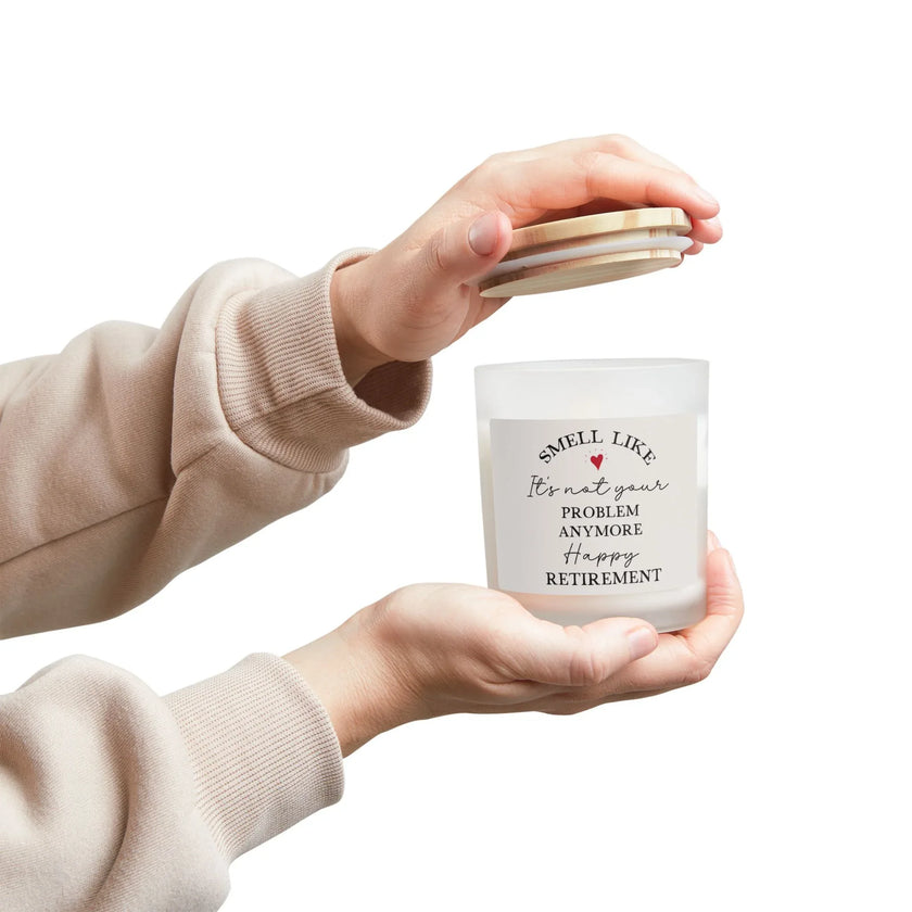 Retirement Gift Candle held in hands, featuring a cheeky retirement message and a frosted glass design.