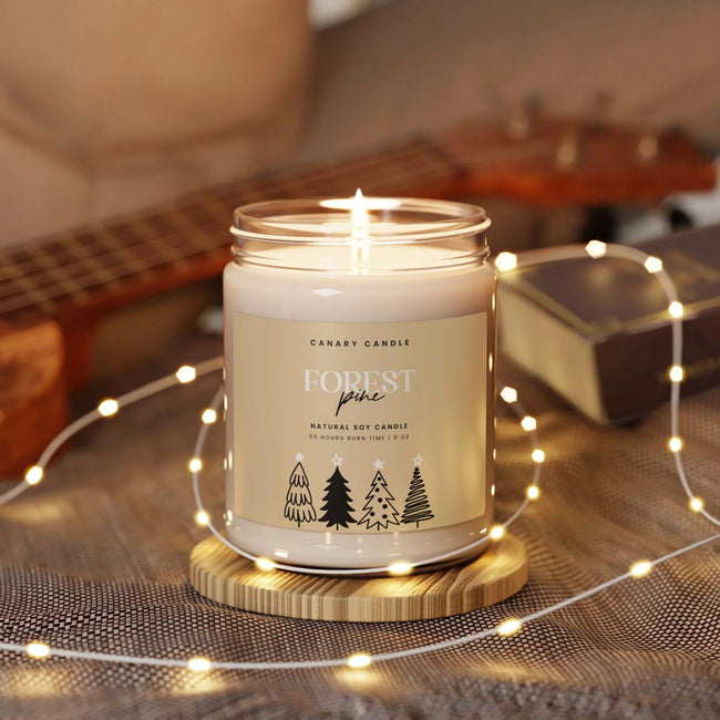 Forest Pine Soy Candle in a glass jar surrounded by fairy lights and a guitar.