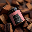 You Are Amazing Cat Scented Soy Candle in amber jar, surrounded by wooden pieces, perfect for cozy evenings. Amazing Soy Candle.