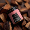 You Are Amazing Cat Scented Soy Candle in amber jar, surrounded by wooden pieces, perfect for cozy evenings. Amazing Soy Candle.