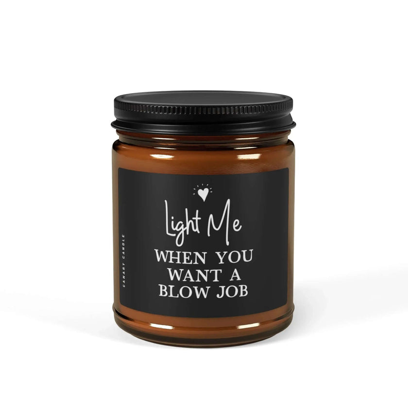 Naughty Soy Candle in brown glass jar with playful label 'Light Me When You Want A BJ' for enticing atmosphere.