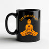 Funny meditation mug featuring a black cup with an orange meditating silhouette and the phrase let that shit go.
