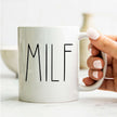 Hand holding MILF Coffee Mug — Funny New Mom Gift Ceramic Mug (11oz & 15oz) with a clean, modern design, PERSONALIZED