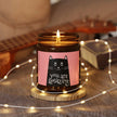 Amazing Soy Candle in amber jar with playful cat label, surrounded by warm lights and a cozy atmosphere.