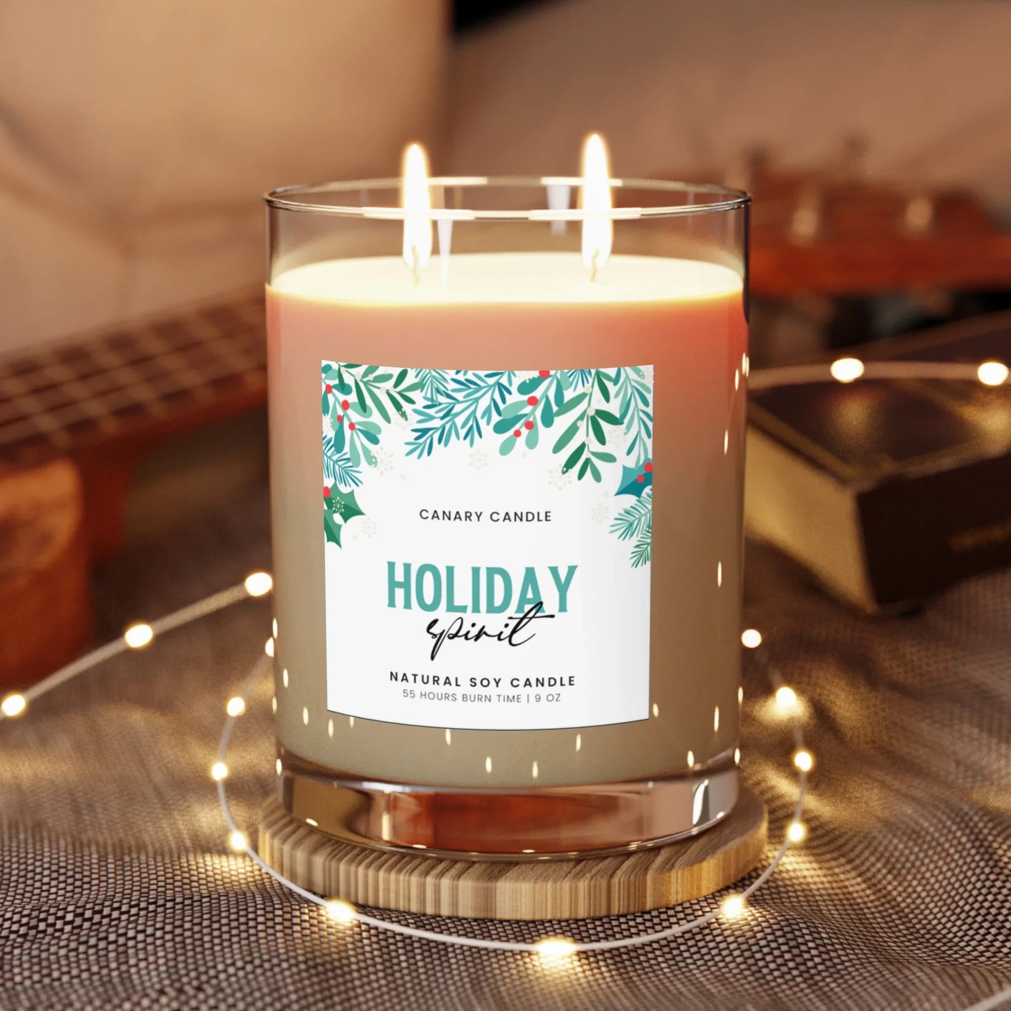 Holiday Spirit Scented Candle in a glass jar with double wicks and festive greenery design on the label.