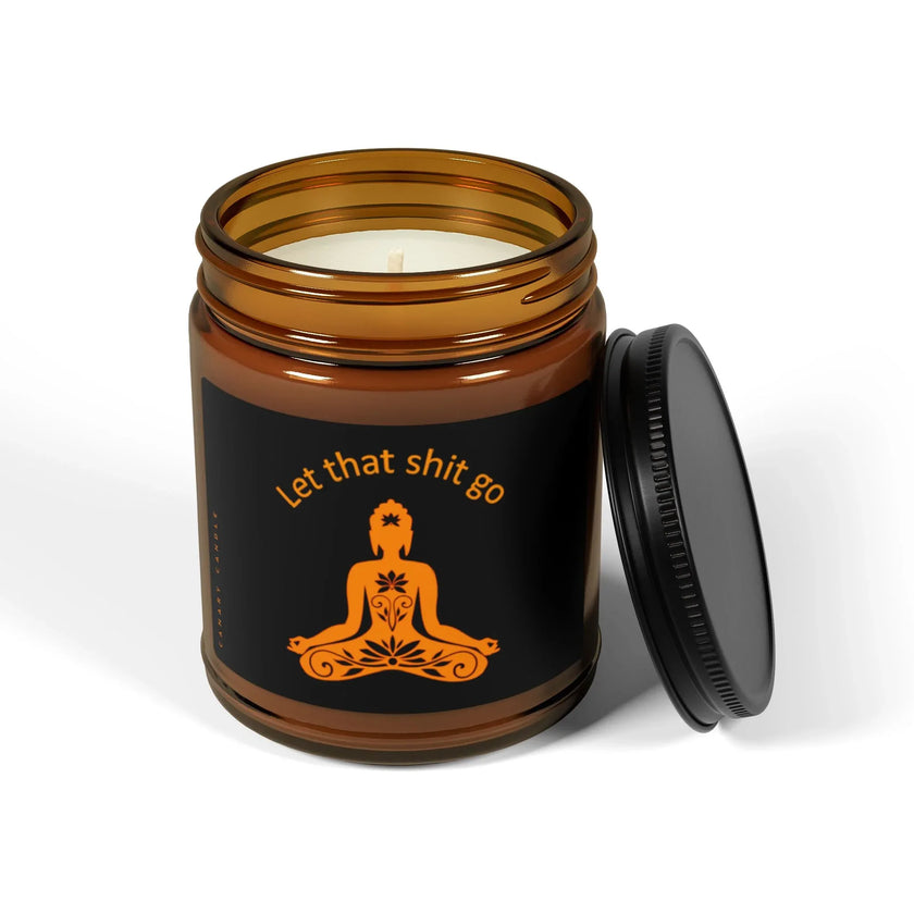 Funny soy candle in warm amber jar with cheeky 'Let that shit go' label and black lid.