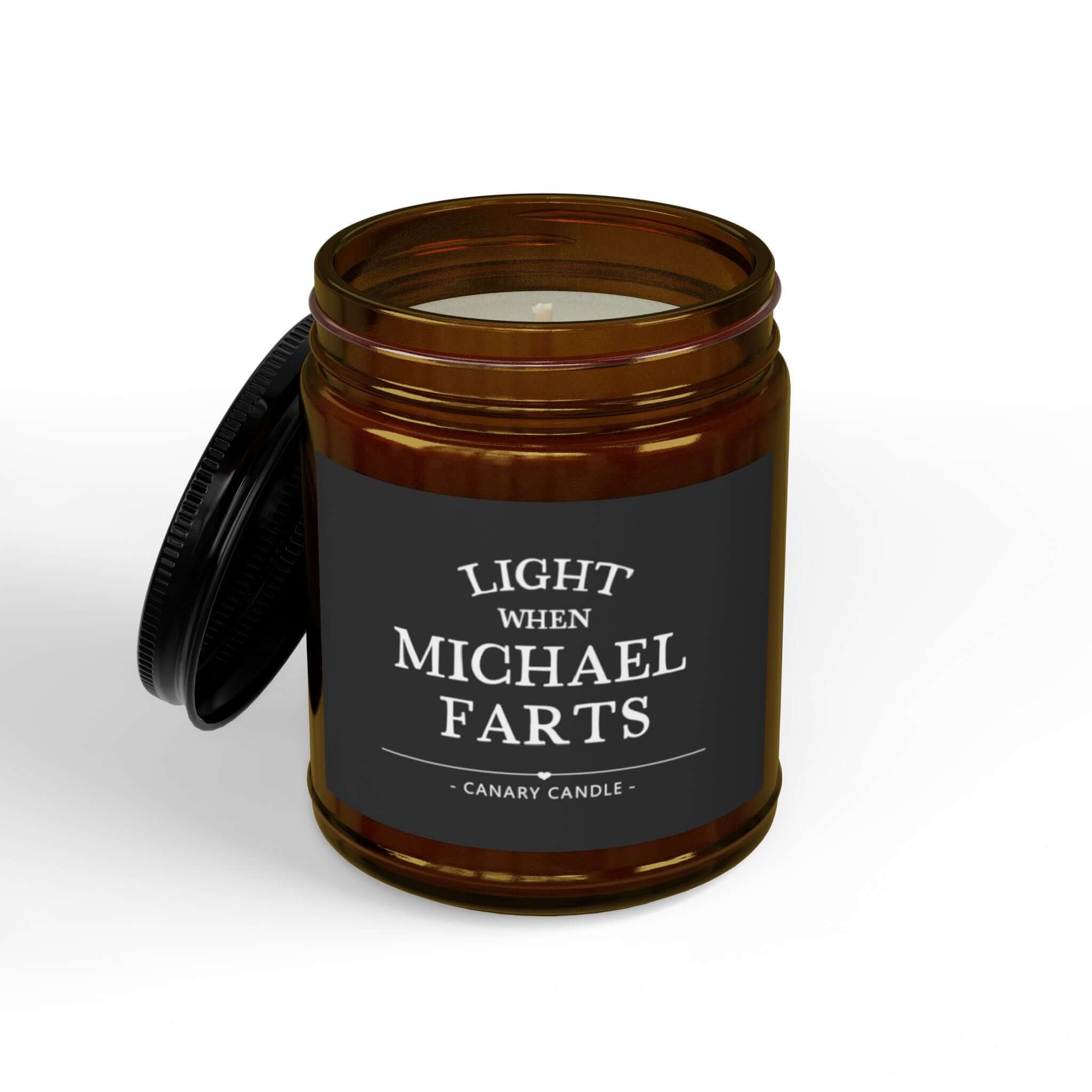 Funny personalized candle in amber jar labeled 'Light When Michael Farts' with black lid.