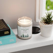 Winter Candle - Forest Scented Soy in a glass jar on a shelf with plants and books.