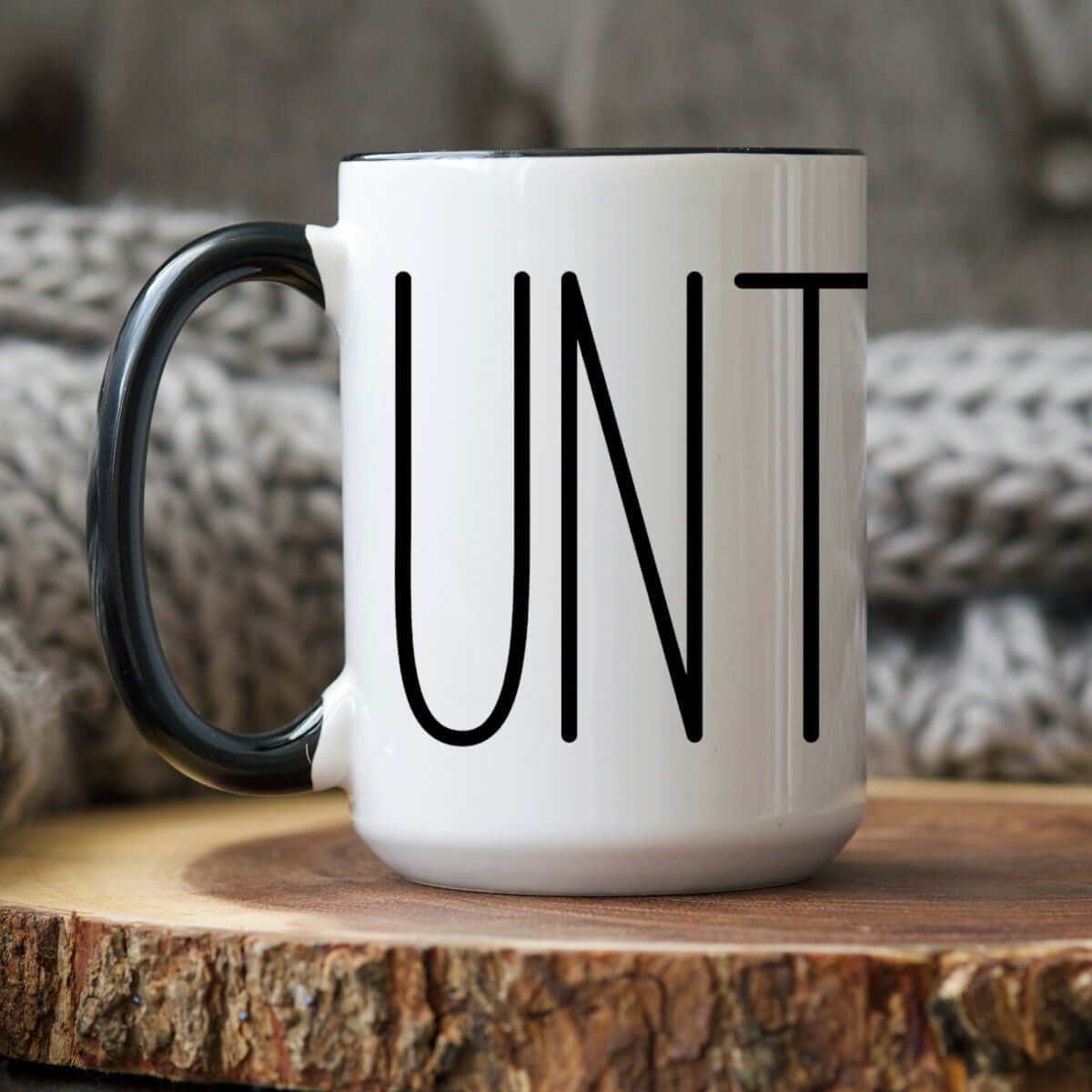 Sarcastic Coffee Mug displaying the word 'UNT', featuring a two-tone design and cozy background.