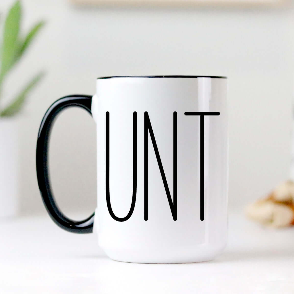Sarcastic Coffee Mug with the word 'UNT' printed in bold, high-quality ceramic with a black handle and two-tone design.